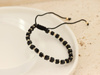 Bransoletka złota czarna sznurkowa ze złotych kulek i czarnych kostek