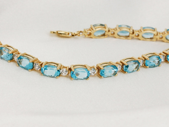 Bransoletka złota z owalnymi niebieskimi kamieniami