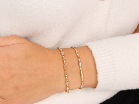 Bransoletka złota dwukolorowa z kuleczkami i podłużnymi elementami