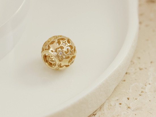 Złota ażurowa kulka charms do bransoletki nawlekana w gwiazdki