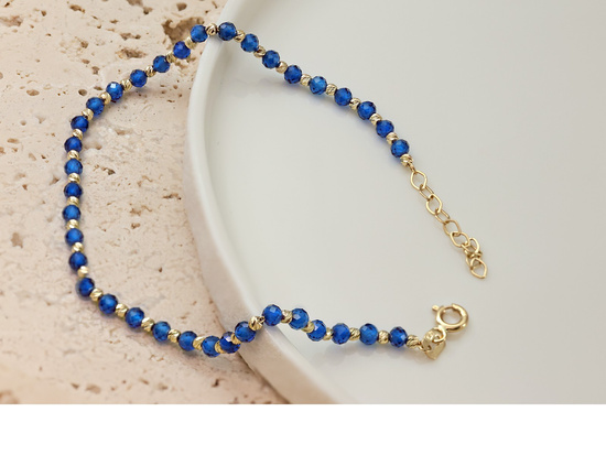 Bransoletka złota z kulkami i syntetycznymi szafirami