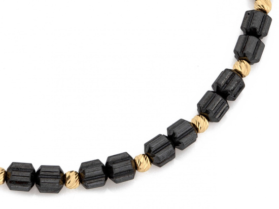 Bransoletka hematyty i złote kulki na czarnym sznurku