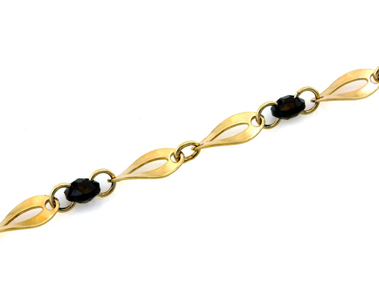 Złota bransoletka owalne ogniwa czarne kamienie