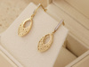 Kolczyki złote wiszące ażurowe z cyrkoniami z białym rodem