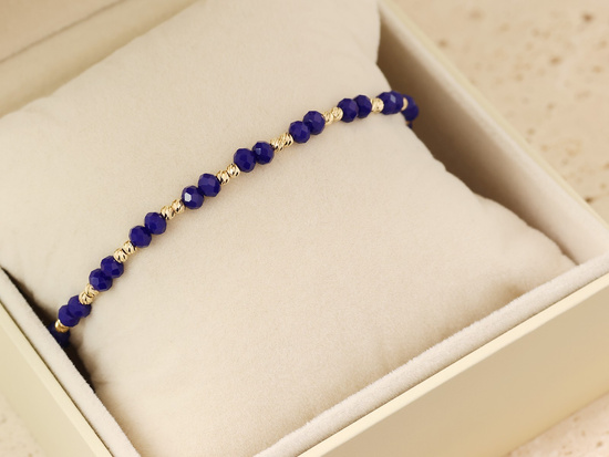 Bransoletka złota z kulkami na niebieskim sznurku