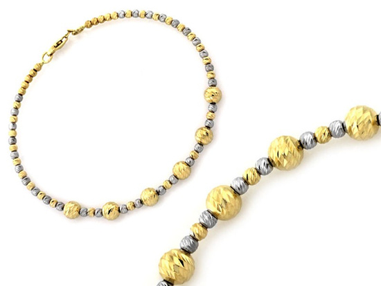 Złota bransoletka sztywna z kulkami