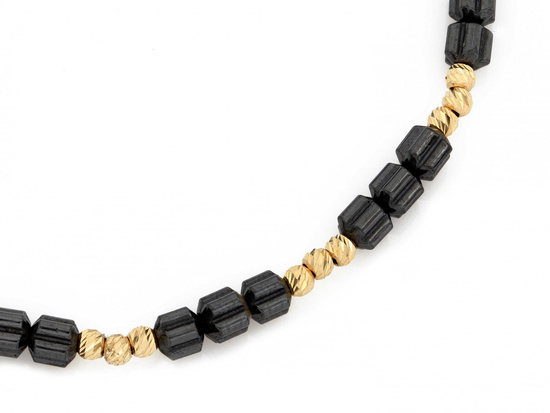 Bransoletka złote kulki i walcowate hematyty na czarnym sznurku