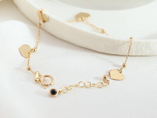 Bransoletka złota z kulkami i wiszącymi sercami