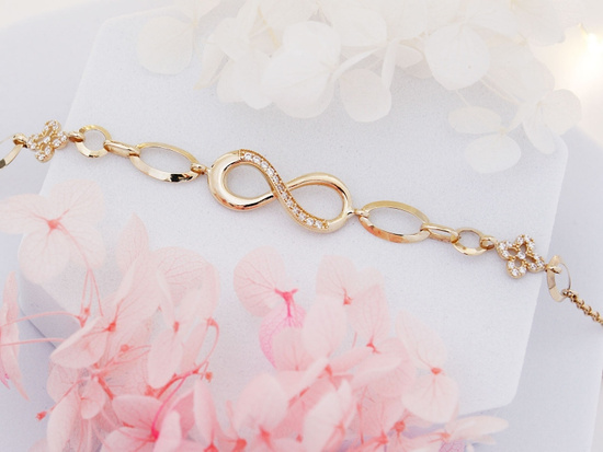 Efektowna złota bransoletka kwiatki nieskończoność z cyrkoniami