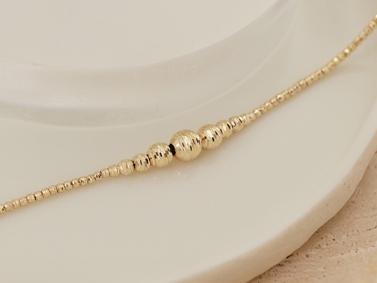 Złota bransoletka modna z kulkami