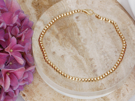 Złota bransoletka z walcowatych elementów