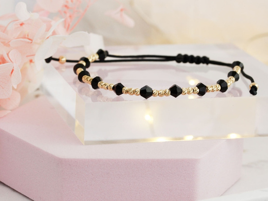 Bransoletka złote kulki i czarne onyksy na czarnym sznurku