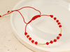 Bransoletka czerwona sznurkowa ze złotymi kulkami