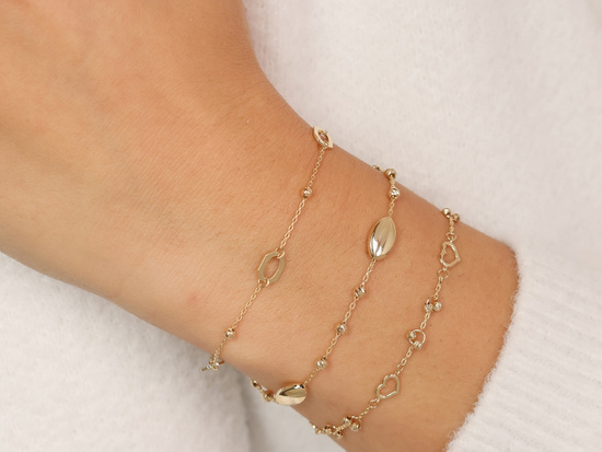 Złota bransoletka łańcuszkowa z kulkami i owalnymi ozdobami