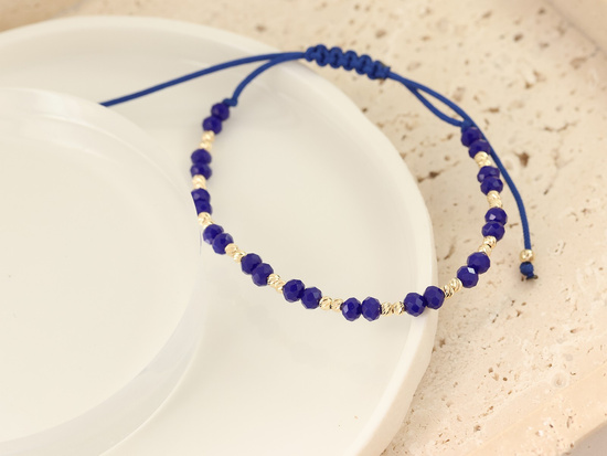 Bransoletka złota z kulkami na niebieskim sznurku