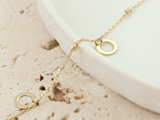 Złota bransoletka łańcuszkowa z kulkami i ringami