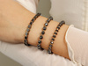Bransoletka złote kulki i hematyty na czarnym sznurku
